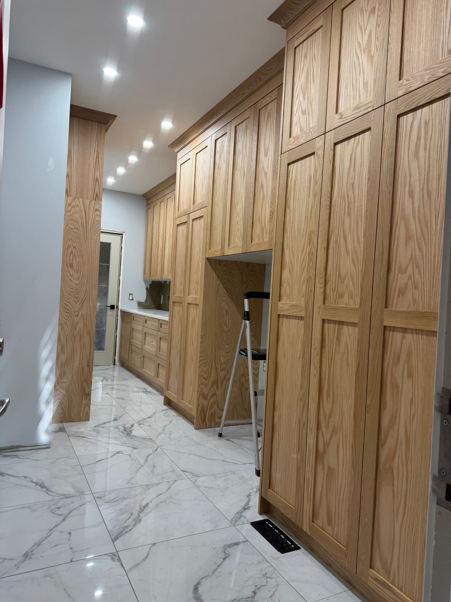 Custom two-tone kitchen with white upper and navy lower cabinets by YYC Cabinets Calgary